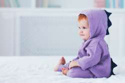 adorable infant wearing dragon costume