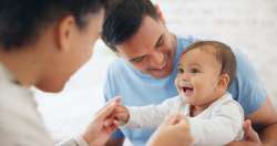 parents holding baby