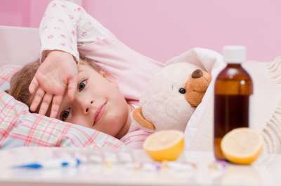 Sick Child Laying in Bed