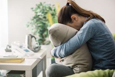Sad Woman Crying Into Pillow