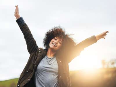 woman letting go of expectations and unnecessary stress who is happier for it