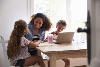 parent helping children with homework