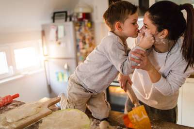 kid and mom having fun in the kitchen