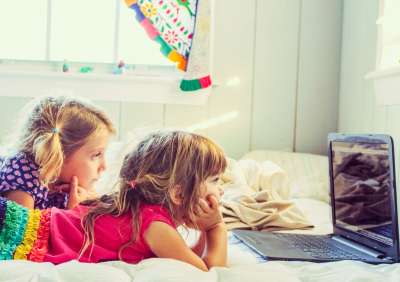 kids mindlessly watching something on a computer or tablet