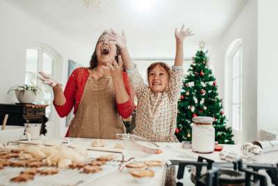 mother and daughter baking christmas cookies