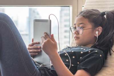 young girl using potentially dangerous apps on ipad