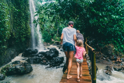 Family hiking near a waterfall on vacation 