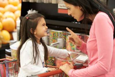 mom disciplining daughter in store