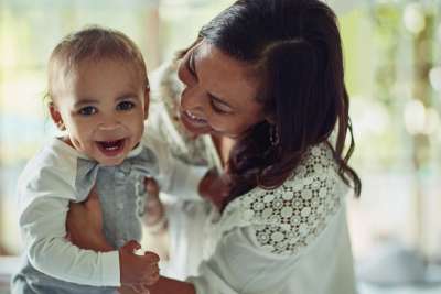 mom holding baby with dimples