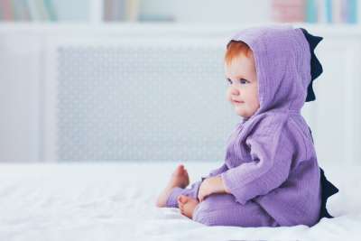 adorable infant wearing dragon costume