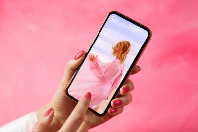 Woman scrolling through TikToks on her phone 