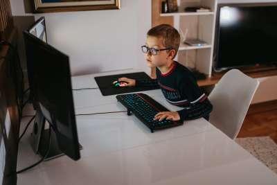 Kid using Roblox voice chat on computer