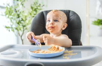 Baby eating pasta
