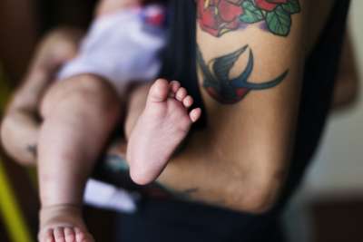 Baby and tattooed parent