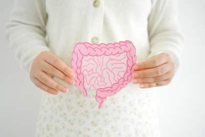 Child holding a digestive system shape