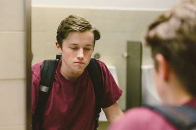 teenager looking into mirror