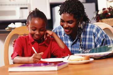 Mother helping daughter study