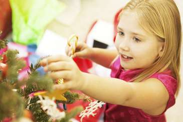 Girl decorating Christmas tree