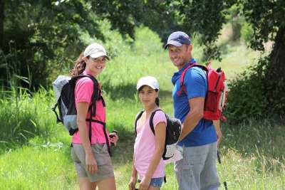 Family of four hiking along trail