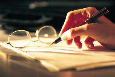 Woman writing with pen in hand
