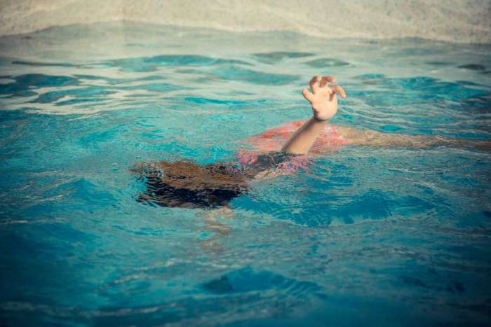 young girl swimming underwater