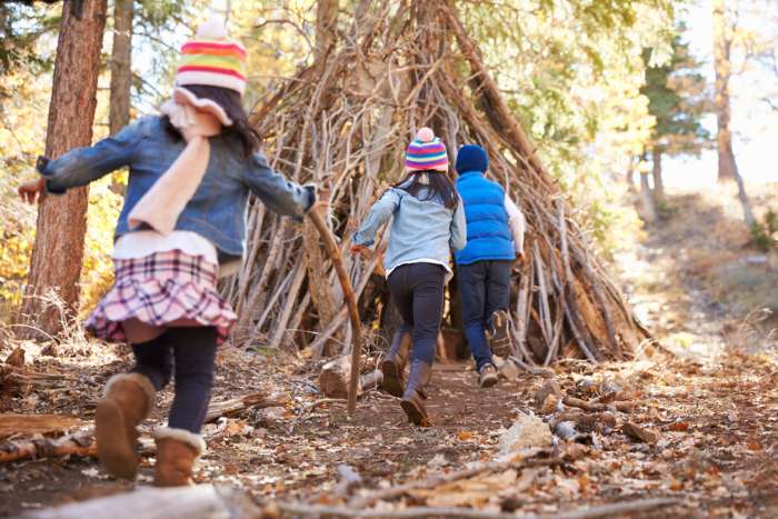 kids on a scavenger hunt in the woods