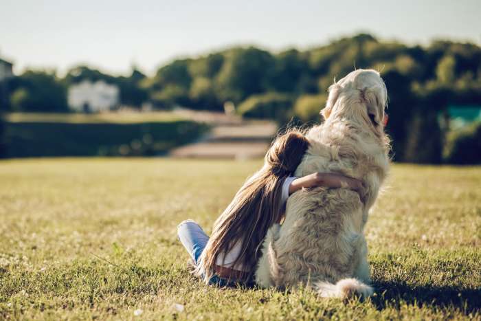 Girl hugging her dog