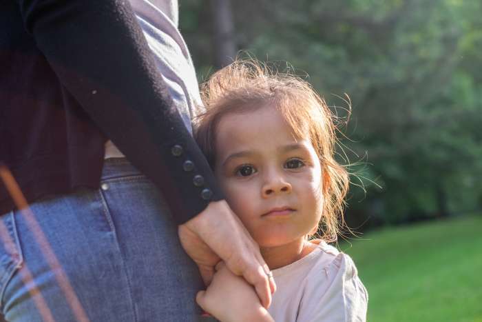 Helicopter parent holding hothouse child's hand
