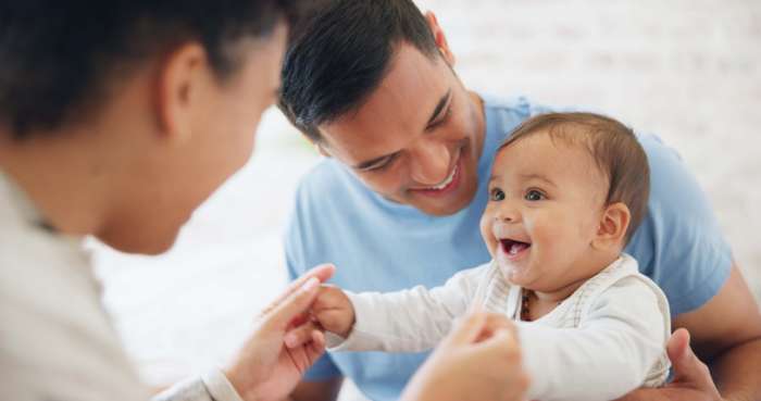 parents holding baby
