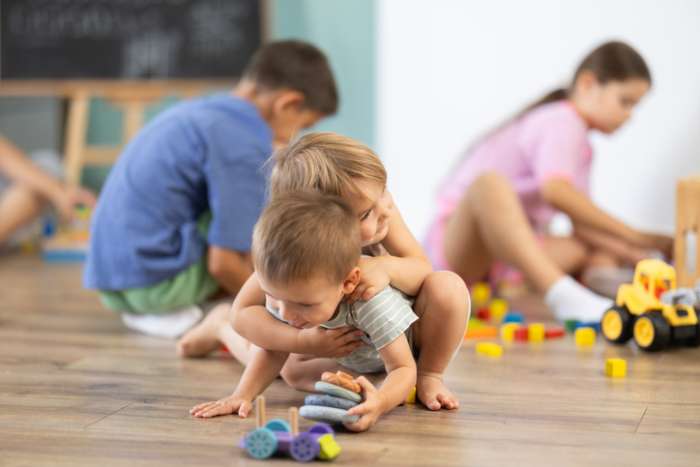 2 children hugging as they play