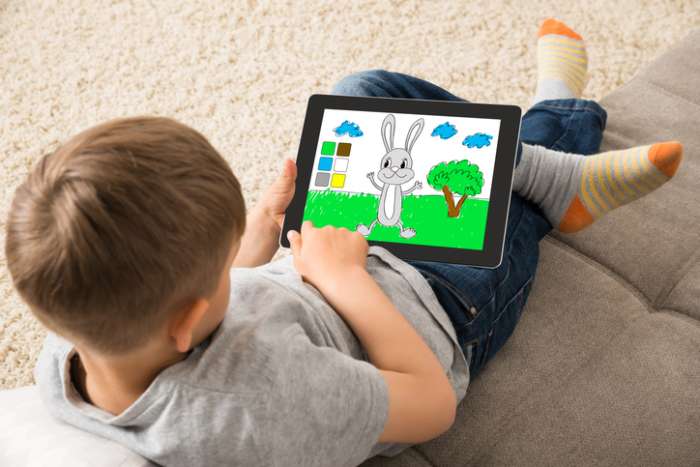 Kid playing on tablet