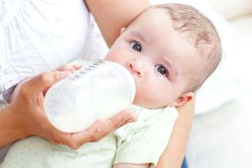 bottle feeding a baby