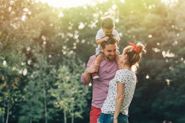 couple in love with son having fun in park