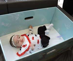 Baby Sleeping in a Box