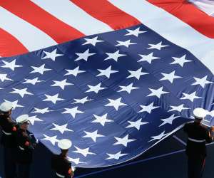 Supporting Our Troops, troops in uniform holding giant US flag