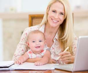 Working mom on laptop with baby on lap